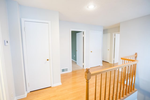 707 Haarfager Ave N, Canby, MN 56220 - corridor featuring light wood-type flooring, an upstairs landing, baseboards, and recessed lighting