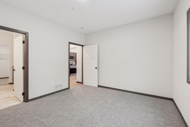 unfurnished bedroom with light colored carpet