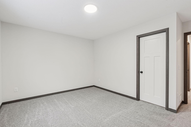 unfurnished room featuring light carpet