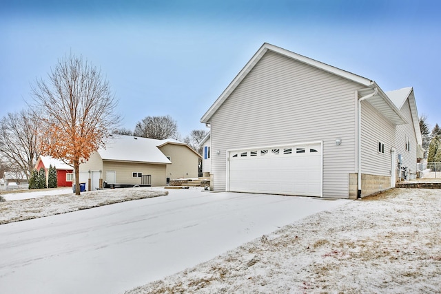 view of snow covered exterior with a garage