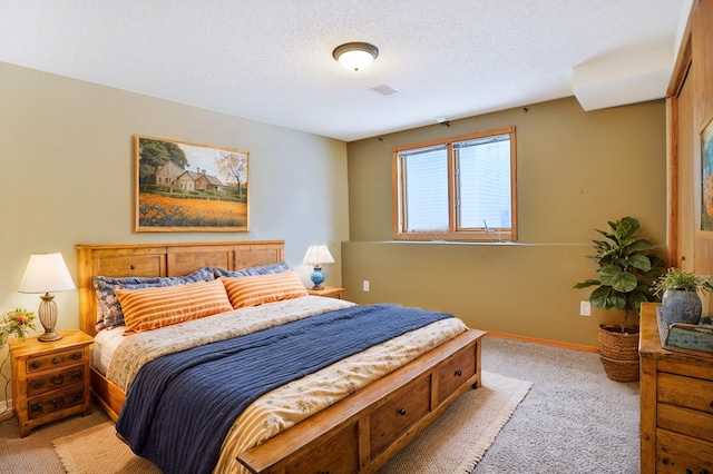 carpeted bedroom featuring a textured ceiling