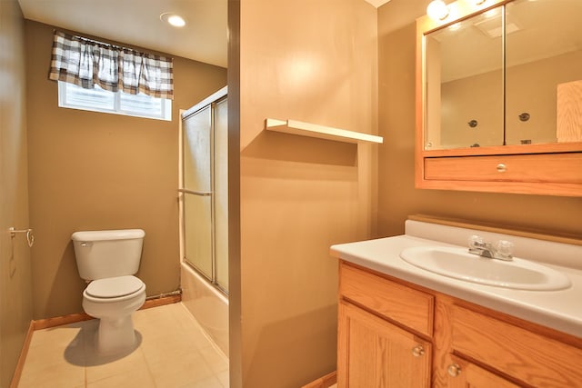 full bathroom featuring combined bath / shower with glass door, vanity, toilet, and tile patterned flooring