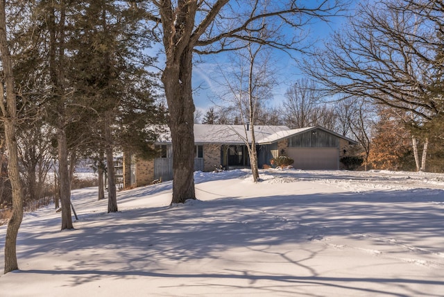 view of front of house with a garage, driveway, and brick siding