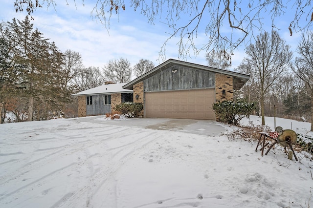 mid-century home with a garage and brick siding