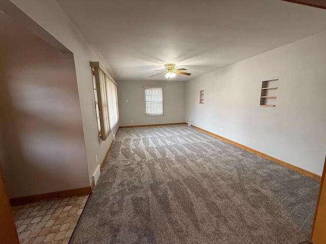 spare room featuring carpet floors and ceiling fan