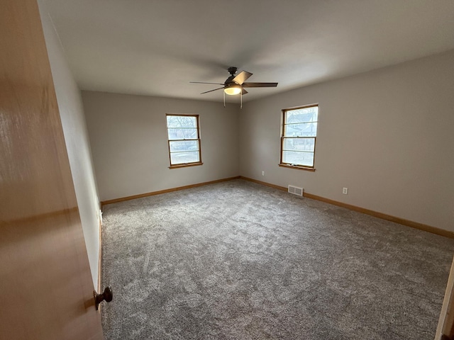 spare room with ceiling fan and carpet floors