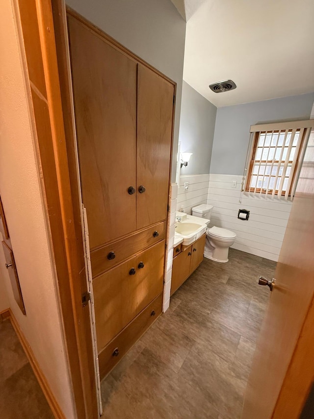 bathroom featuring vanity and toilet