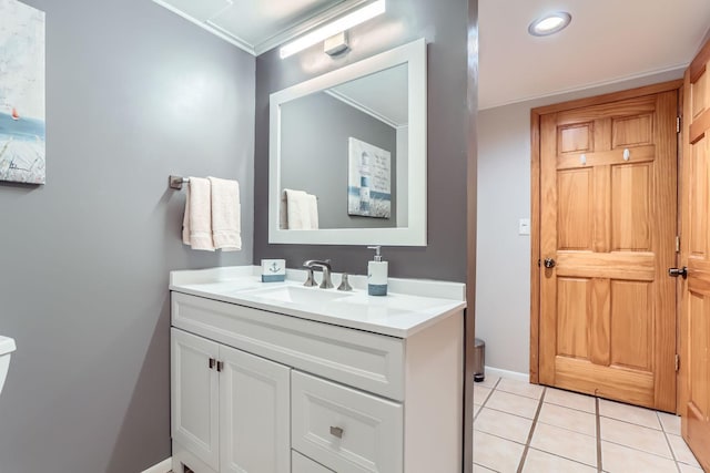 bathroom featuring crown molding, tile patterned flooring, and vanity