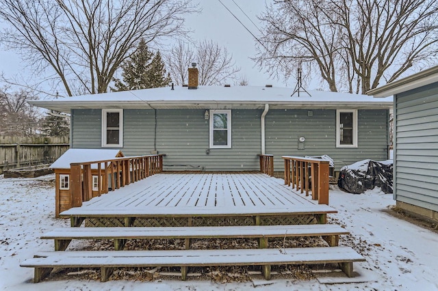 snow covered property with a deck