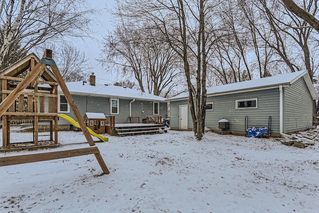 view of snow covered back of property