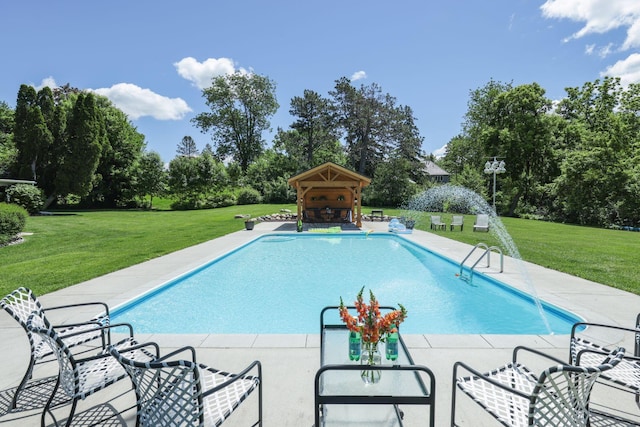 view of pool with a patio area and a yard