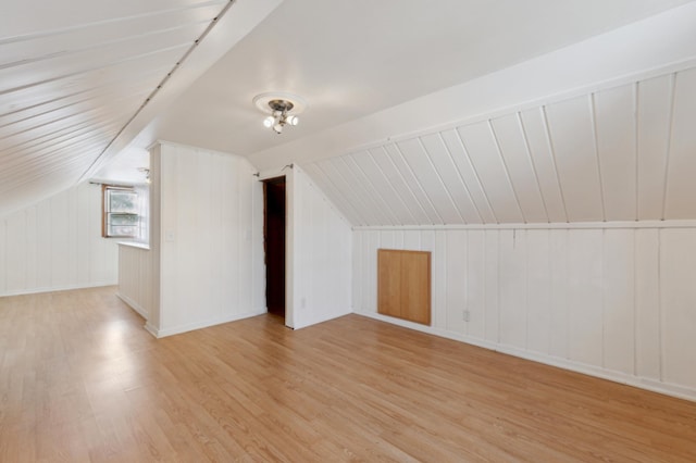 bonus room with lofted ceiling and light hardwood / wood-style floors