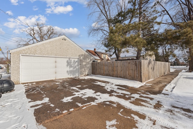 snow covered property with a garage