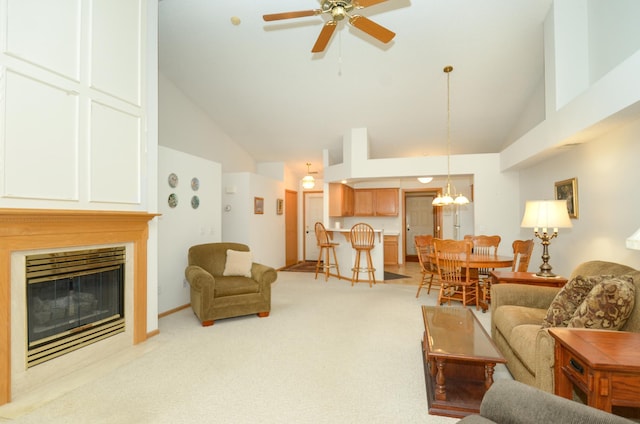 carpeted living room with high vaulted ceiling and ceiling fan