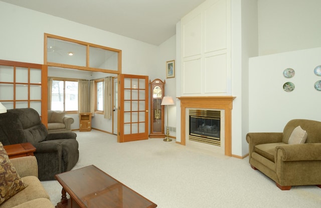 living room featuring lofted ceiling, french doors, and carpet flooring