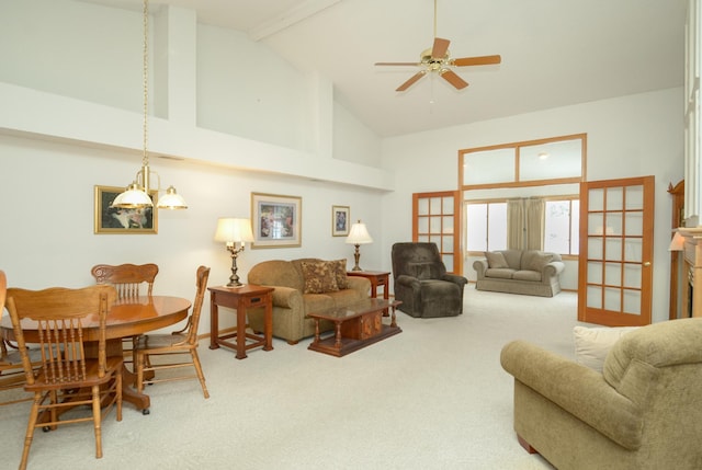 carpeted living room with high vaulted ceiling and ceiling fan