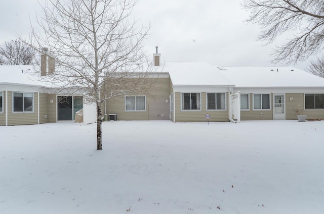 view of snow covered back of property