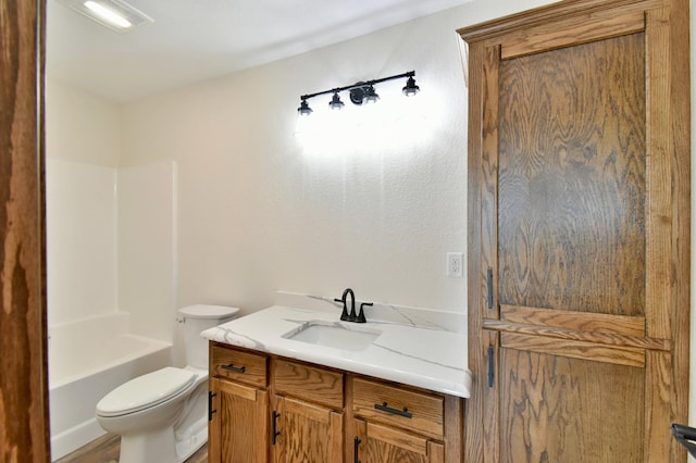 full bathroom with vanity, toilet, and  shower combination