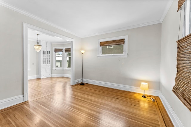 empty room with crown molding and hardwood / wood-style flooring