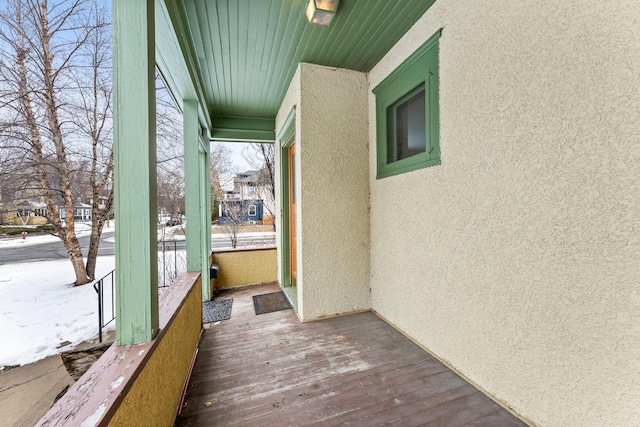 snow covered deck with covered porch