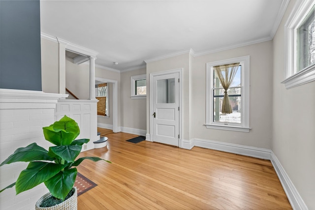 foyer with wood-type flooring and ornamental molding