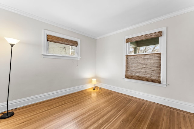 unfurnished room with hardwood / wood-style flooring and crown molding