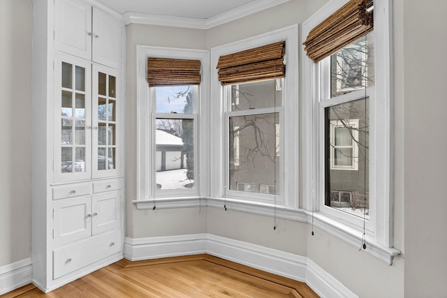 interior space with hardwood / wood-style floors and ornamental molding