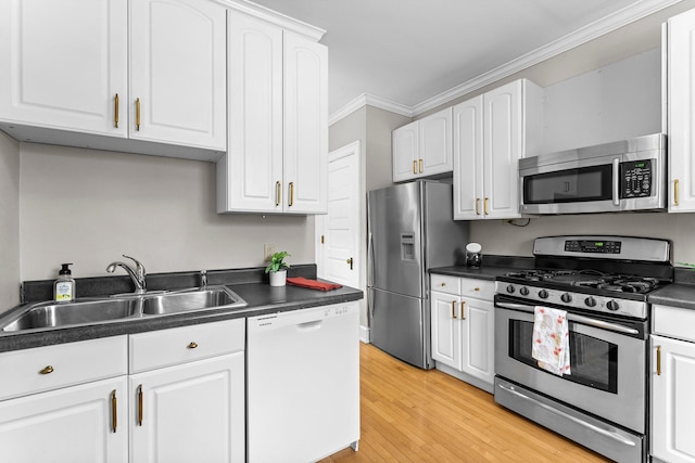 kitchen featuring white cabinets, appliances with stainless steel finishes, light hardwood / wood-style floors, sink, and crown molding