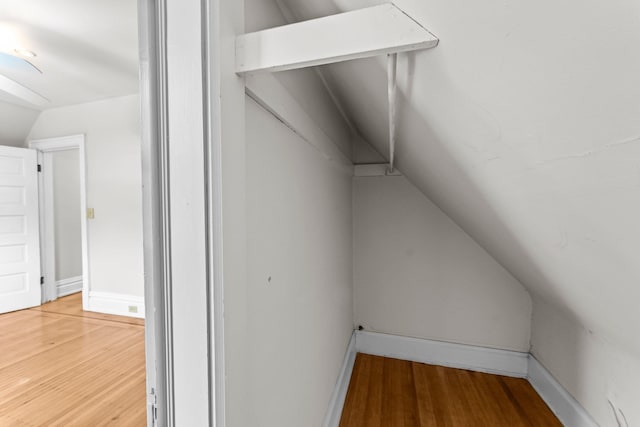 spacious closet with wood-type flooring and lofted ceiling