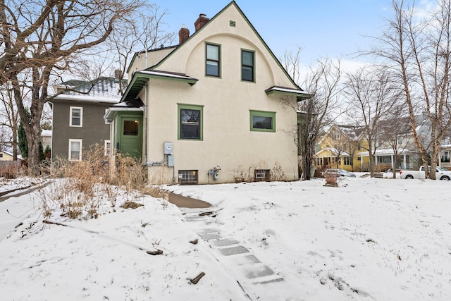 view of snow covered rear of property