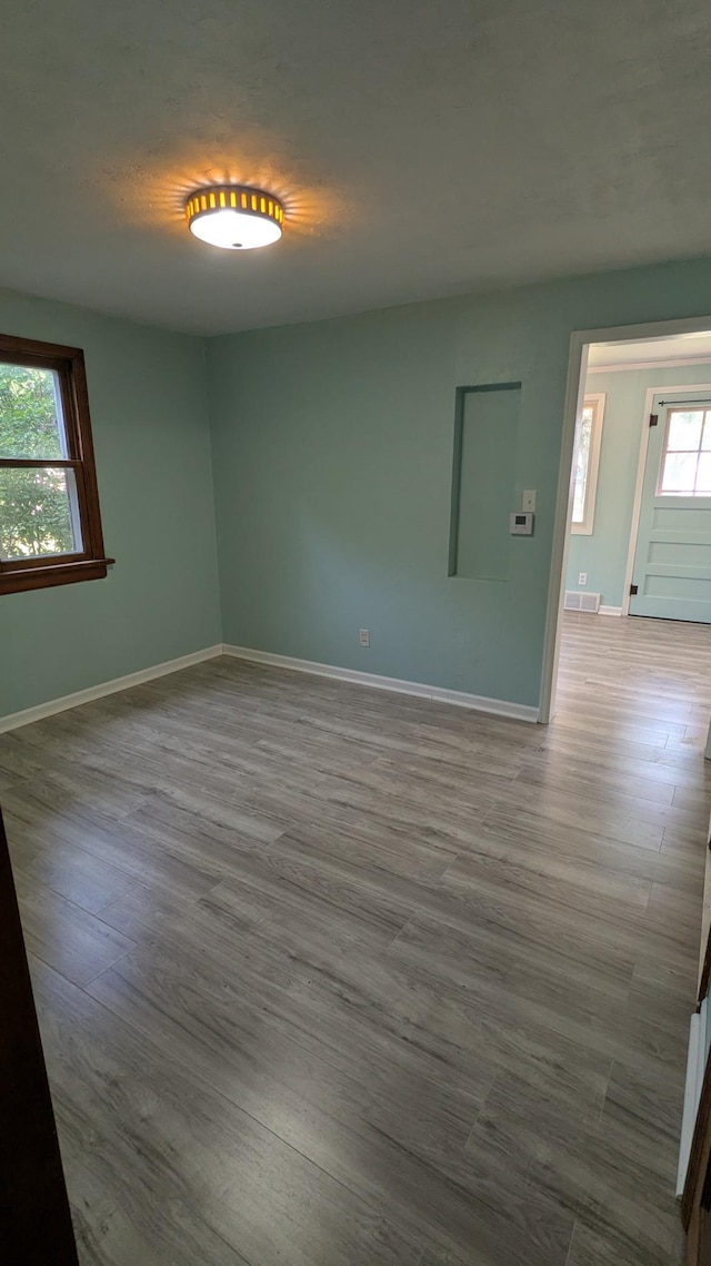 2114 5th Ave NE, Austin, MN 55912 - unfurnished room featuring baseboards and wood finished floors
