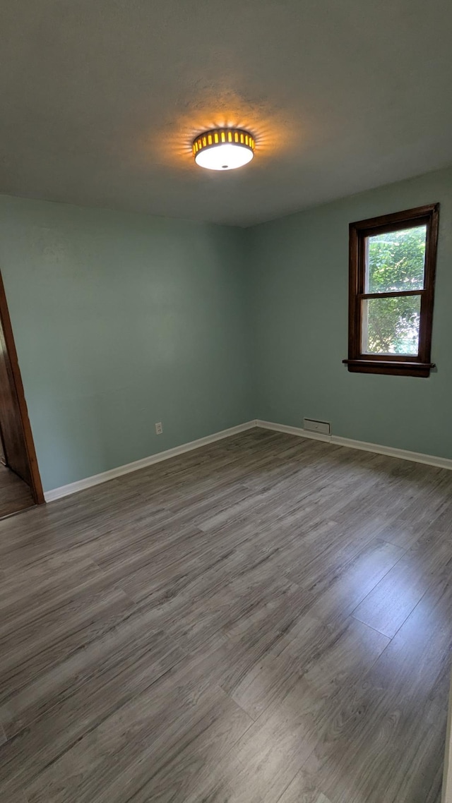 2114 5th Ave NE, Austin, MN 55912 - empty room with dark wood-style floors and baseboards