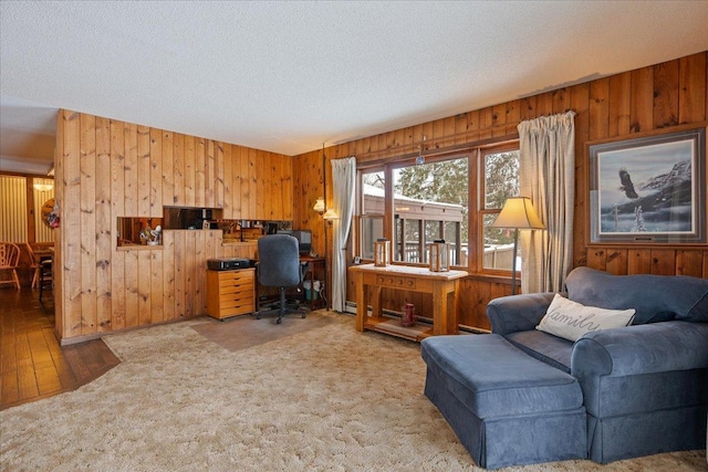 carpeted office space featuring wooden walls and a textured ceiling