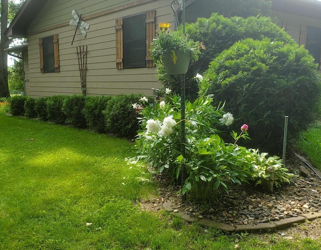 view of side of home featuring a lawn