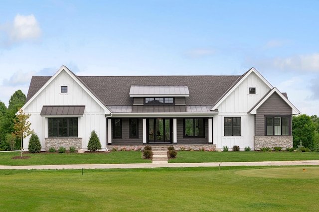 modern farmhouse style home with a front lawn