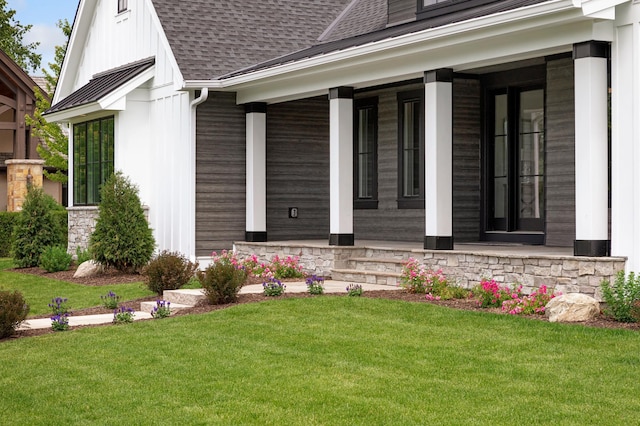 property entrance featuring a porch and a yard