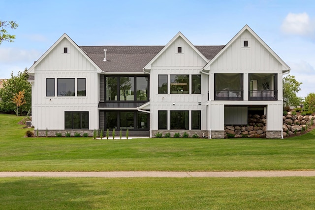 rear view of property featuring a yard