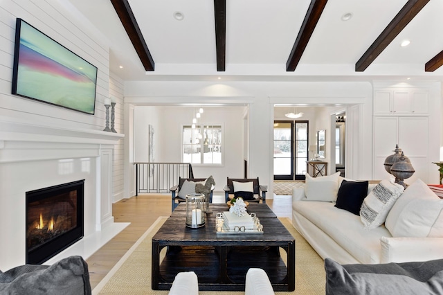 living room with beam ceiling and light wood-type flooring