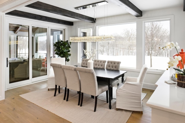 sunroom / solarium with a chandelier