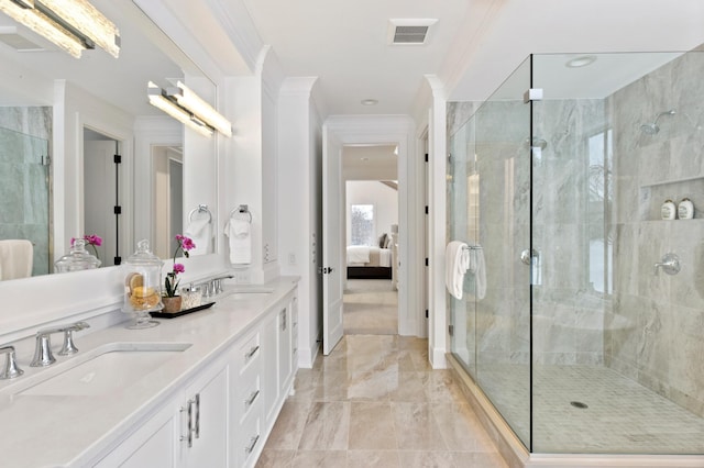 bathroom with crown molding, vanity, and an enclosed shower