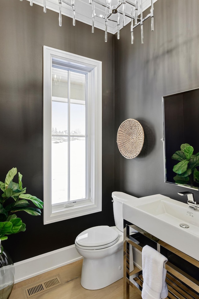 bathroom featuring hardwood / wood-style flooring and toilet