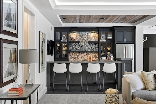 bar with wood ceiling, stainless steel fridge, and pendant lighting