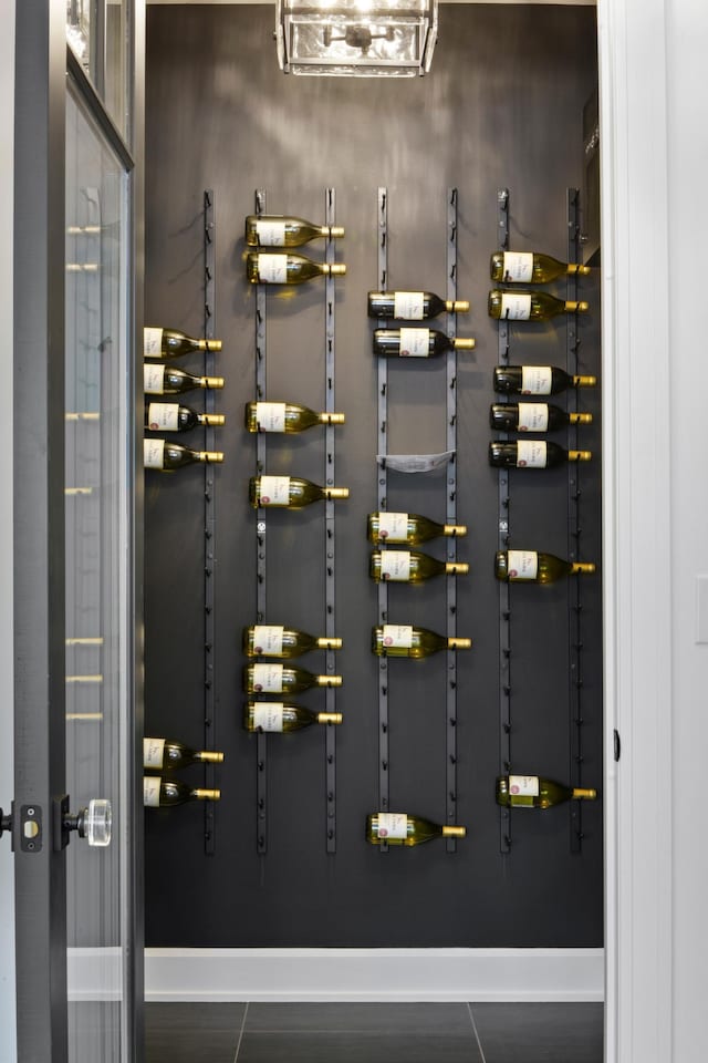 wine room with dark tile patterned flooring