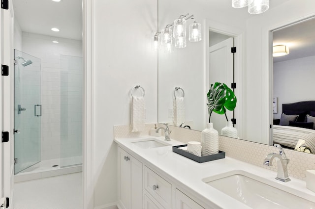 bathroom with decorative backsplash, a shower with door, and vanity