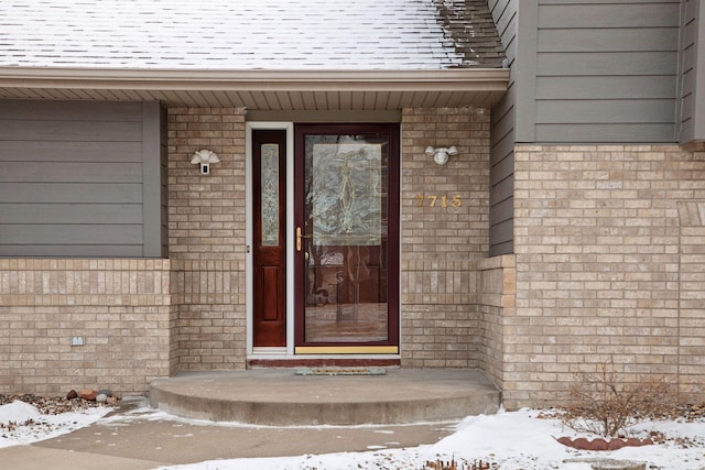 view of snow covered property entrance