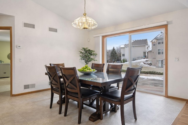 dining room featuring lofted ceiling and a chandelier