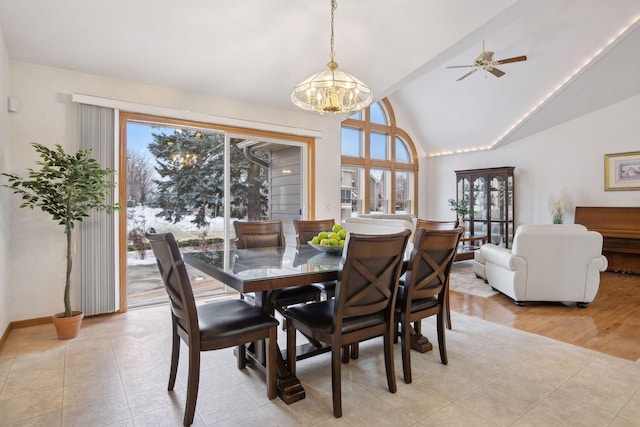 dining space featuring a chandelier, light tile patterned floors, and high vaulted ceiling