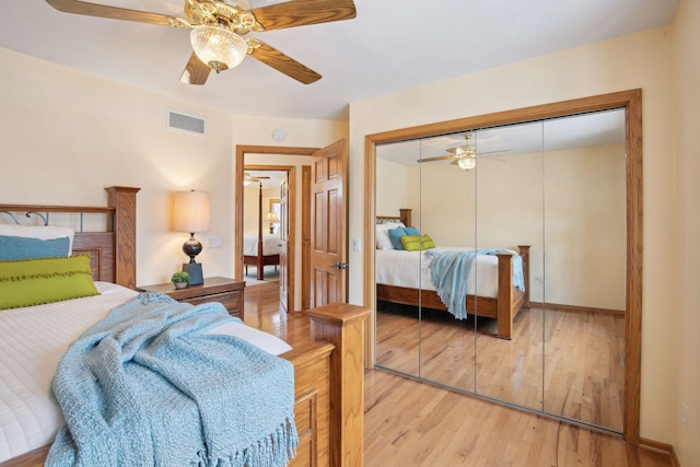 bedroom featuring wood-type flooring, a closet, and ceiling fan