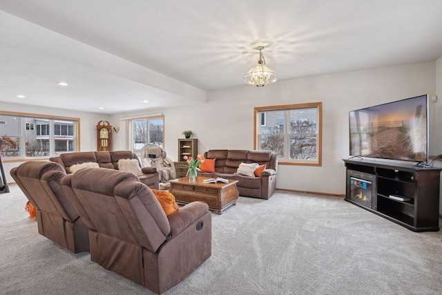 living room with an inviting chandelier and light carpet