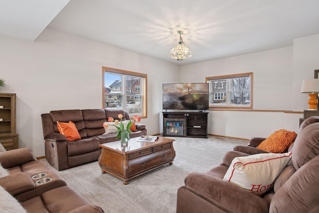 living room with light carpet and a notable chandelier